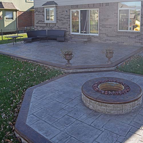 Stamped concrete patio with octagonal firepit