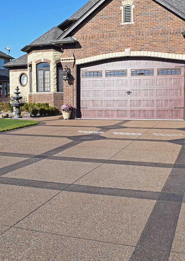 Exposed Aggregate Driveway with Stained Accents in Clinton Township, Michigan