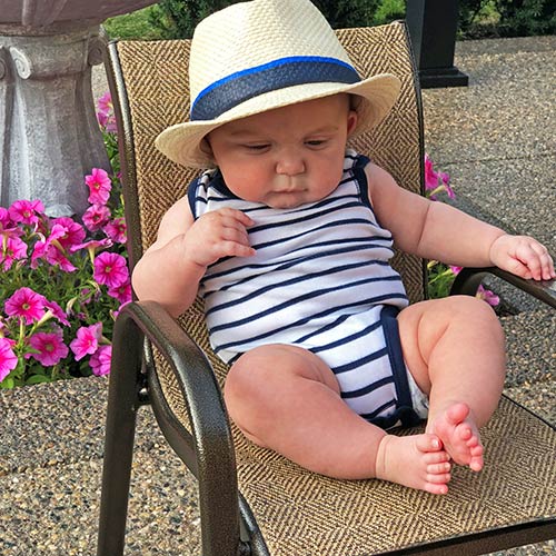 Baby enjoying a beautiful exposed aggregate patio