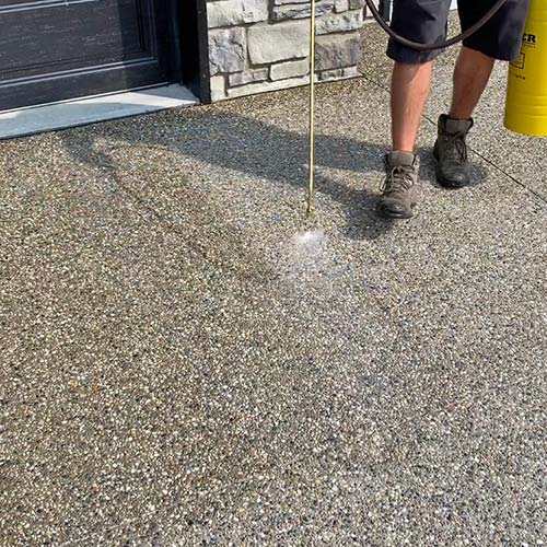 Applying a fresh coat of sealant to exposed aggregate in Macomb County
