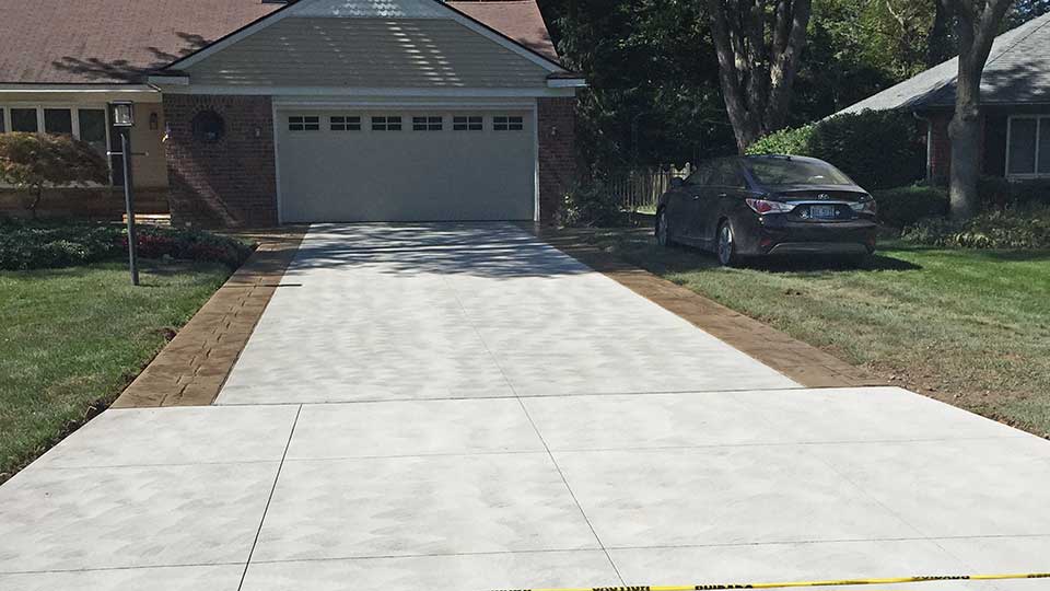 Plain Concrete Driveway with Stamped Concrete Ribbons in Macomb Township, Michigan